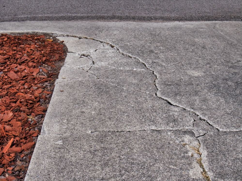Concrete pavement cracking recorded in a pre-construction dilapidation survey for property condition reporting