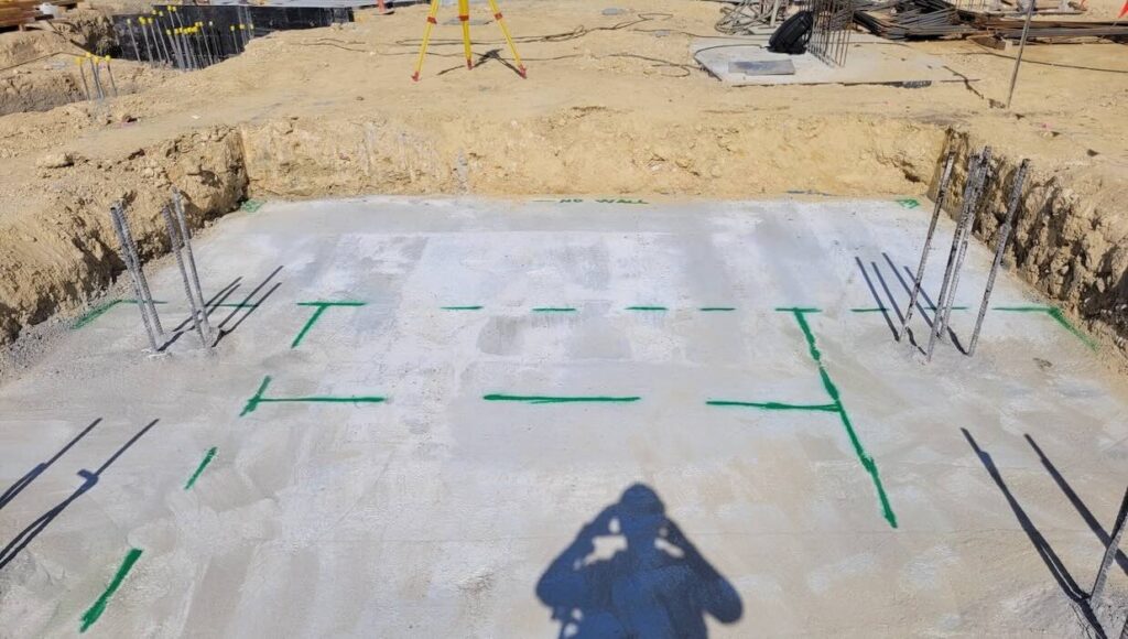 As-built survey markings on a concrete foundation slab at Brunswick LIV construction site in Melbourne